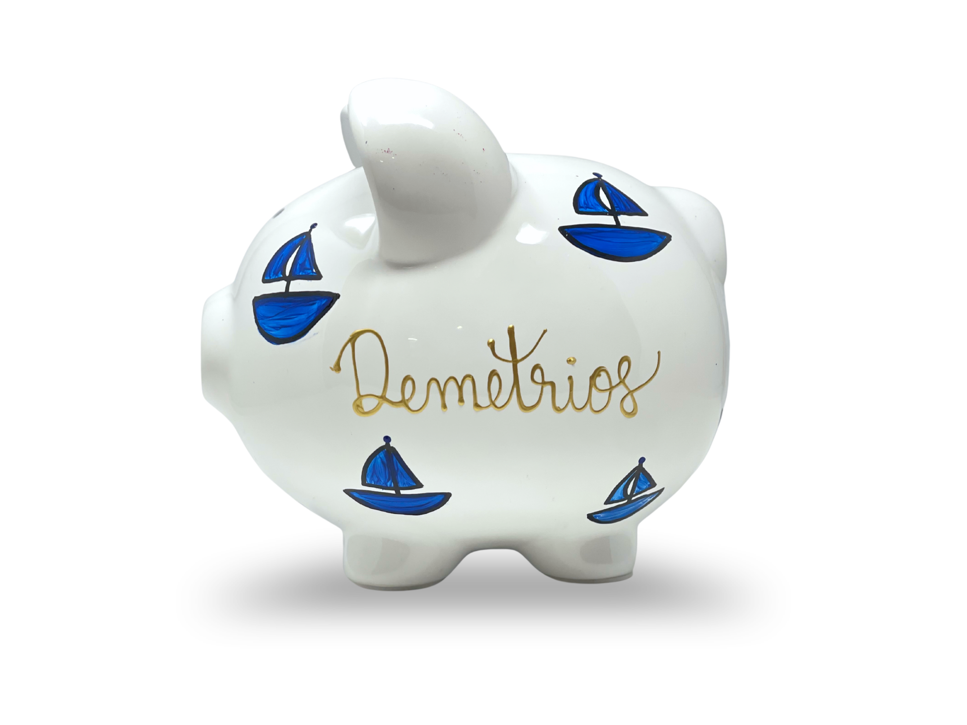 White piggy bank with blue sailboats and 'Demetrios' written on a white background