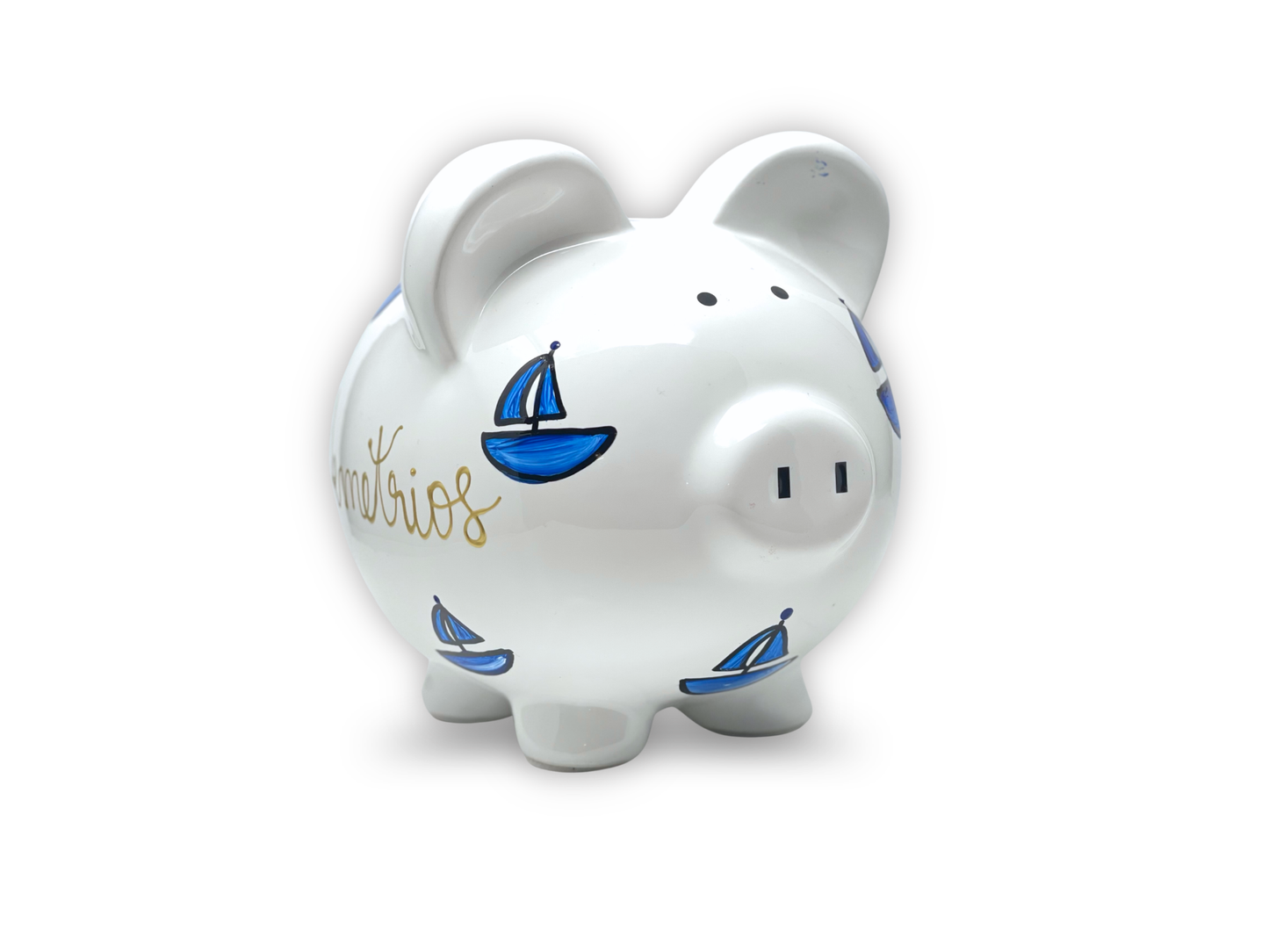 White piggy bank with blue sailboat designs on a white background