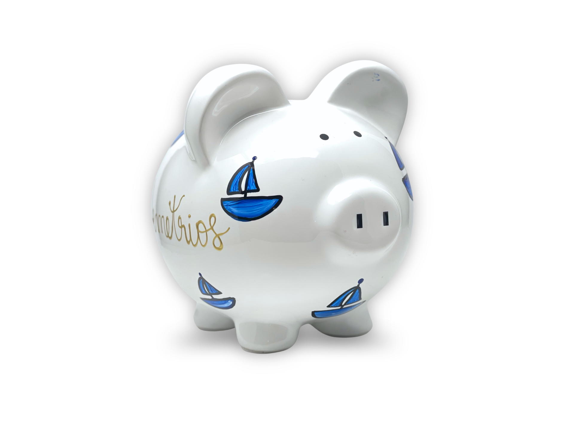 White piggy bank with blue sailboat designs on a white background