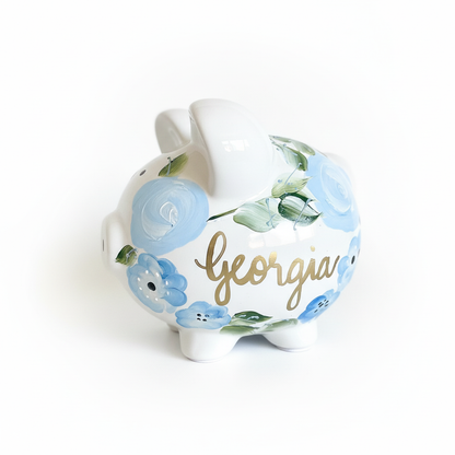 Decorative piggy bank with floral design and 'Georgia' text on a white background