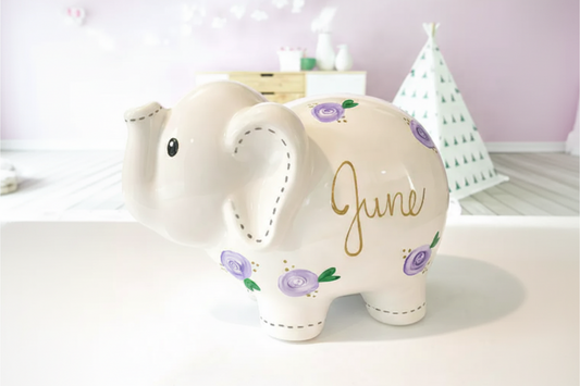 Decorative elephant with 'June' written on it, surrounded by festive decorations.