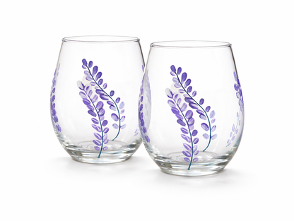 Two glass tumblers with purple floral designs on a white background