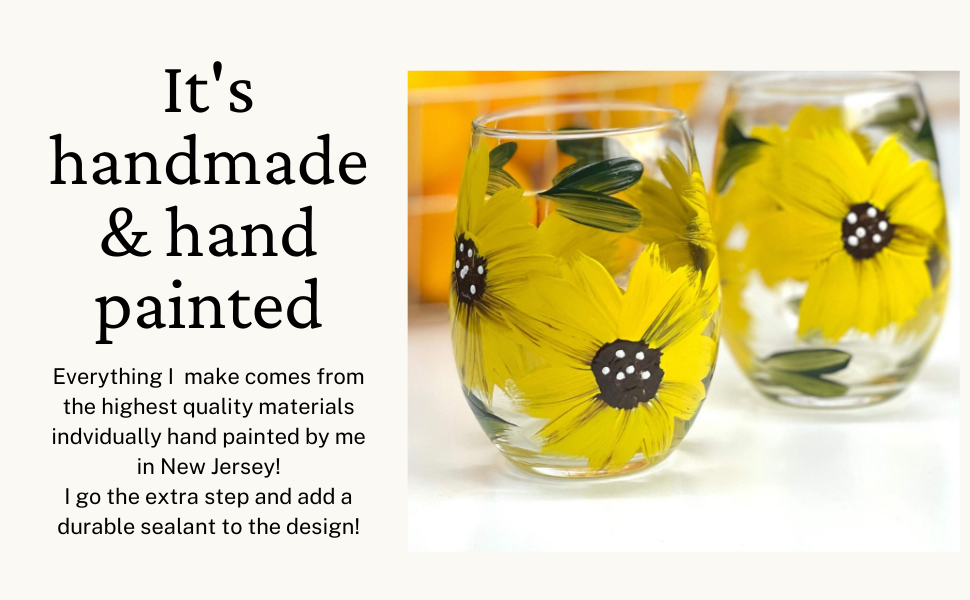 Close-up of painted sunflower design on stemless wine glass

