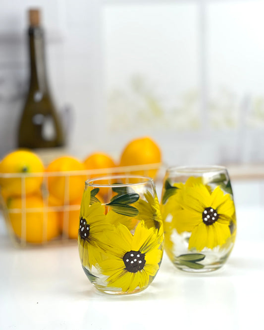 Hand painted sunflower stemless wine glasses, set of 2, with vibrant yellow sunflowers and green leaves, ideal for summer wine enjoyment and sunflower-themed kitchen decor."