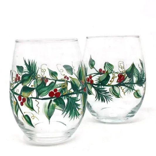 Two glass tumblers with festive greenery and berries design on a white background